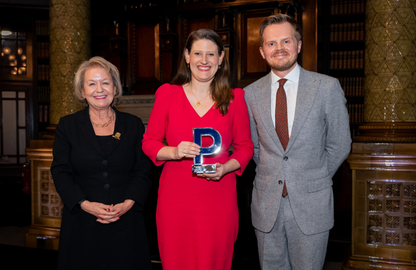 Theo Clarke MP holding her award for Best Political Speech of the Year, flanked by Dame Rosie Winterton and Pagefield's Oliver Foster